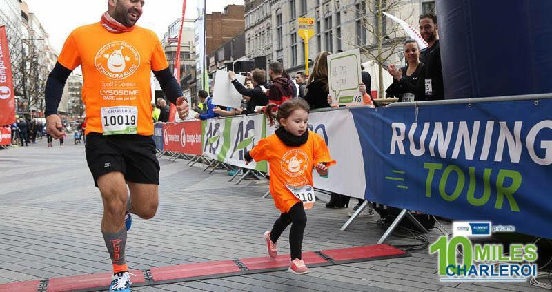 papa et enfant franchissant la ligne d'arrivée avec leurs Teeshrit lysosome